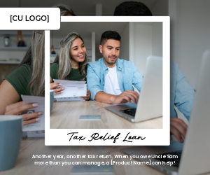A happy couple sits at a table with a laptop and a folded piece of paper.