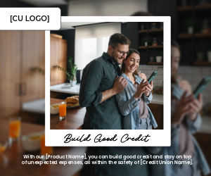 A couple embraces while standing in their kitchen. They are looking at a cell phone and are smiling.