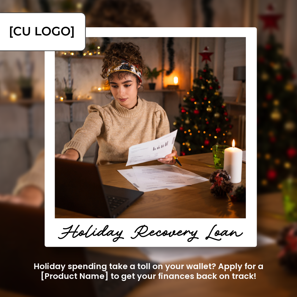 A woman sits at table with a pile of bills and a laptop. A Christmas tree is in the background.