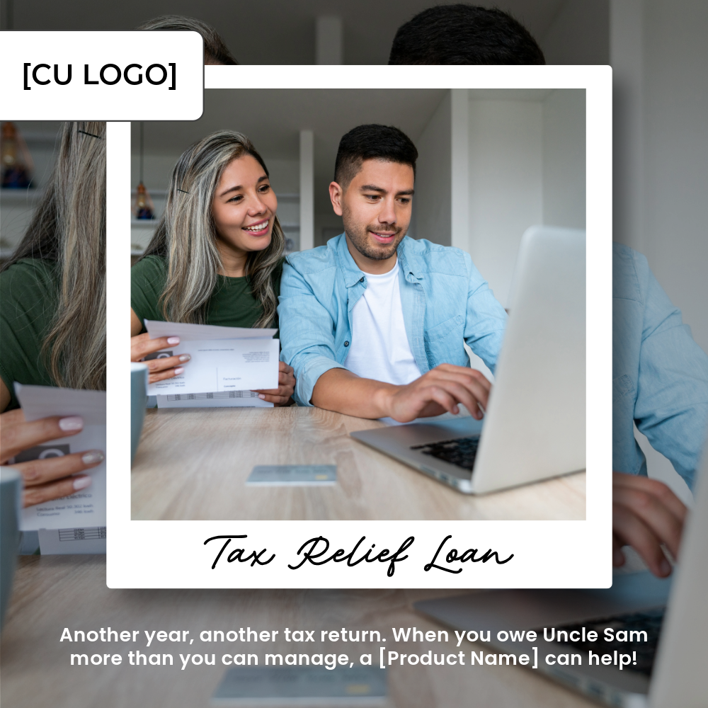 A happy couple sits at a table with a laptop and a folded piece of paper.