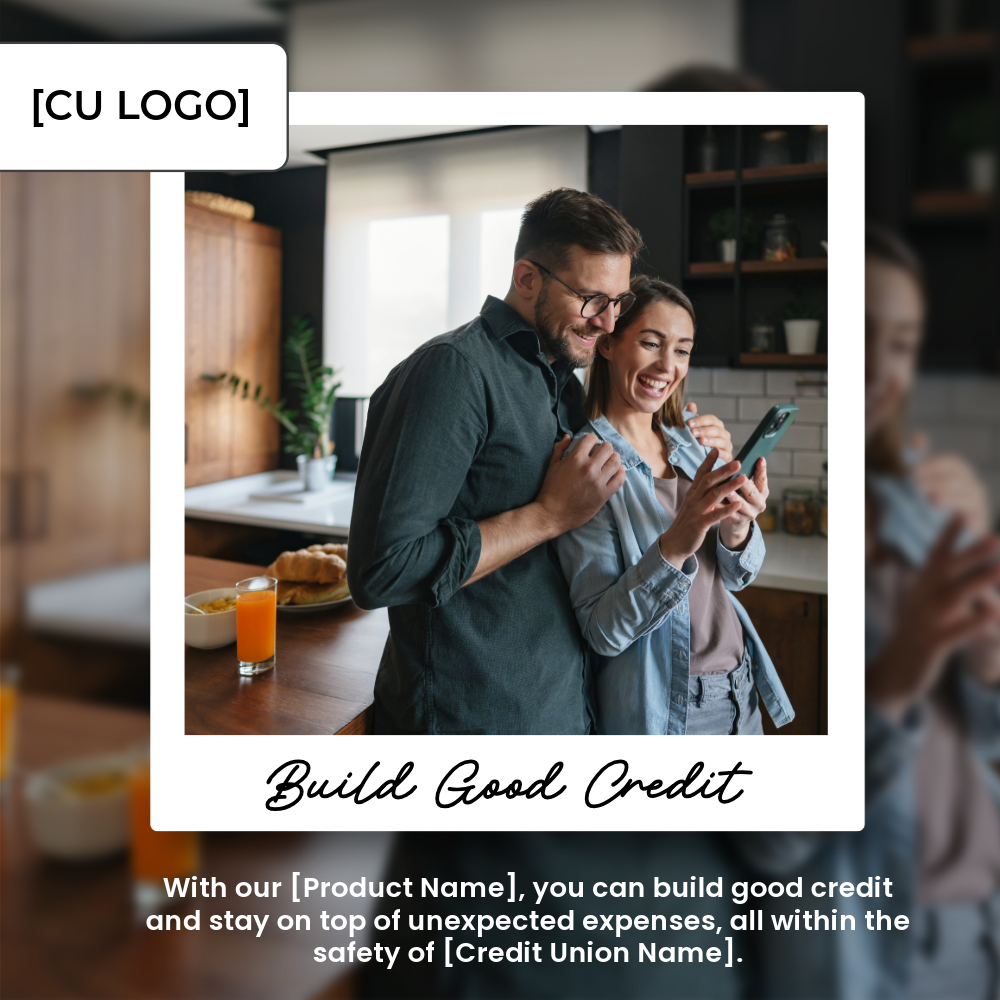 A couple embraces while standing in their kitchen. They are looking at a cell phone and are smiling.